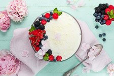 Berry layered dessert with curd cheese and Frischk&mdash;se